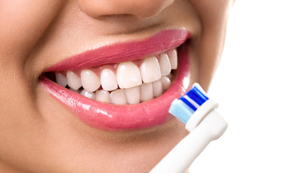 Close up of perfect teeth during brushing and oral care