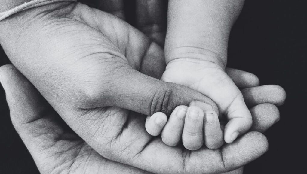Parent and child and caregiver holding hands